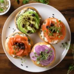 Different variations of lox bagels with unique toppings